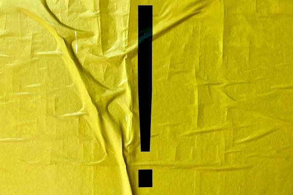 A black exclamation mark against a crumpled yellow paper background. Photo by Bekky Bekks on Unsplash