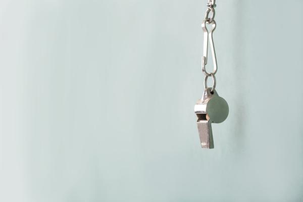 Image of a silver whistle hanging on a string