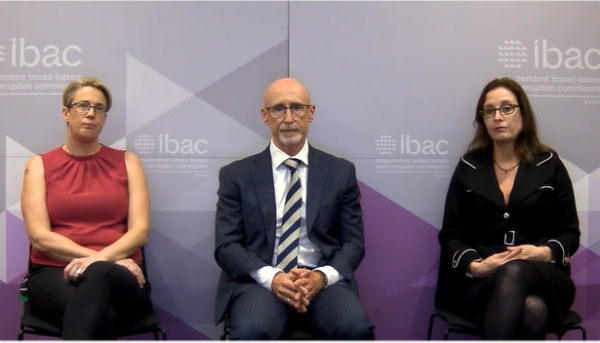 guest speakers sitting in front of a purple ibac banner